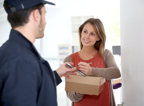 Woman sigining electronic receipt of delivered package.jpeg